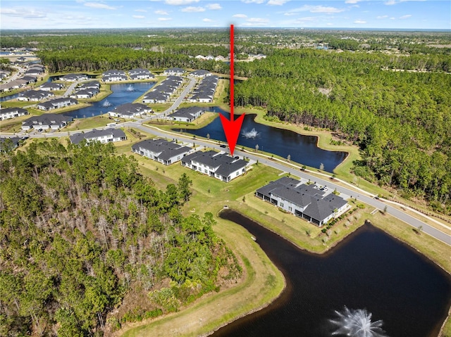 aerial view with a residential view, a water view, and a view of trees