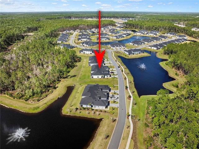 bird's eye view featuring a water view and a wooded view