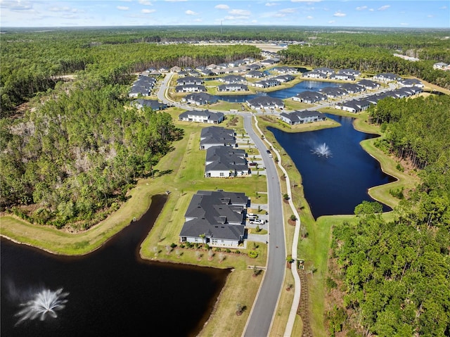 aerial view featuring a residential view, a water view, and a wooded view