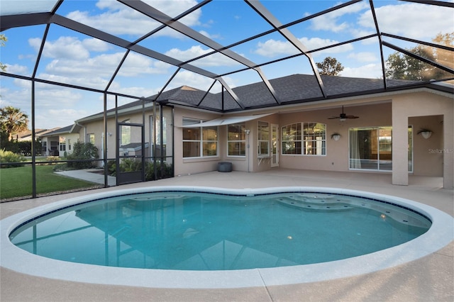 outdoor pool with glass enclosure, a patio, and ceiling fan