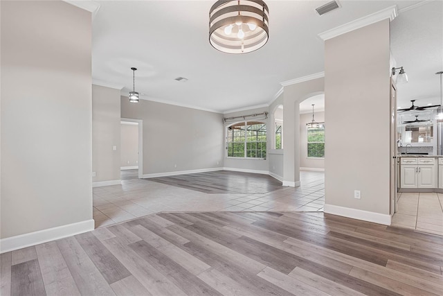 unfurnished living room featuring visible vents, light wood-style flooring, arched walkways, a sink, and crown molding