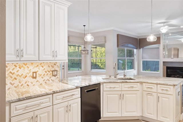 kitchen featuring a sink, light stone counters, backsplash, crown molding, and dishwasher