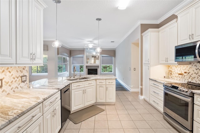 kitchen featuring ceiling fan, ornamental molding, light tile patterned flooring, stainless steel appliances, and a sink