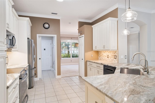 kitchen with crown molding, light stone counters, light tile patterned flooring, stainless steel appliances, and a sink