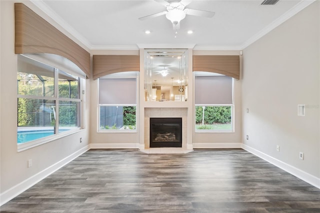 unfurnished living room featuring dark wood finished floors, plenty of natural light, and crown molding