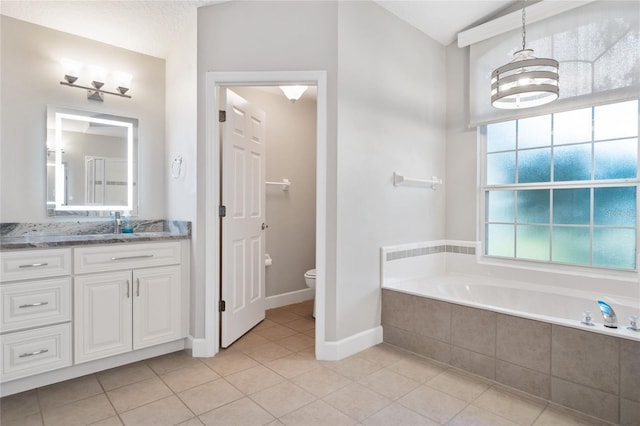 bathroom with vanity, a garden tub, tile patterned floors, toilet, and a chandelier