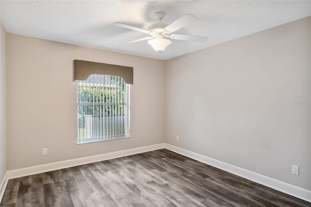 unfurnished room featuring baseboards, a textured ceiling, dark wood finished floors, and a ceiling fan