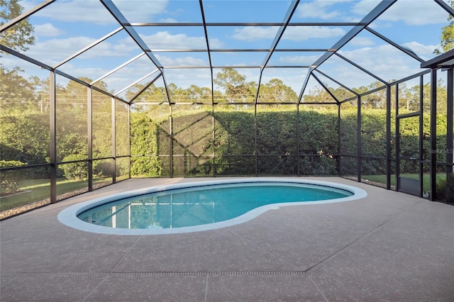 pool with a lanai and a patio area