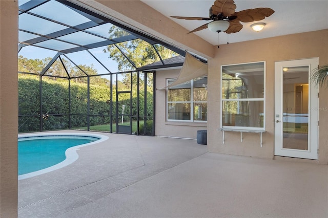 pool with glass enclosure and a patio