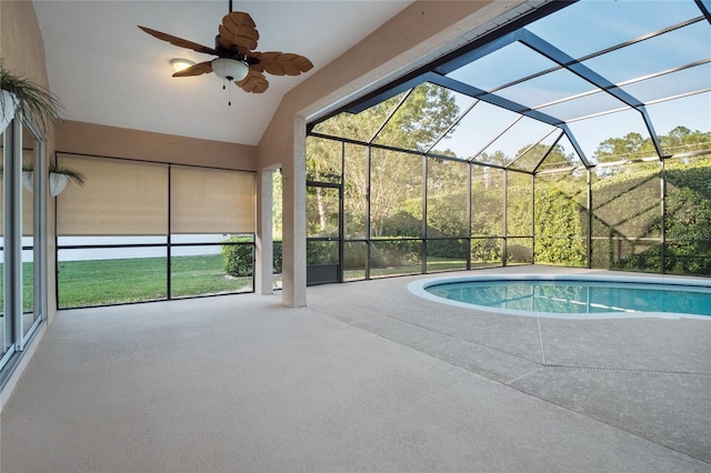 outdoor pool featuring a patio area, glass enclosure, and ceiling fan