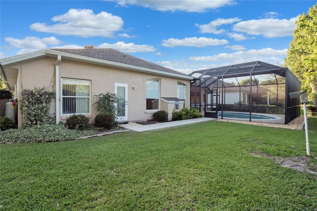 back of property with a lanai, roof with shingles, stucco siding, a lawn, and an outdoor pool