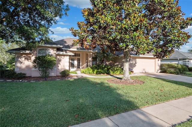 obstructed view of property featuring a garage, french doors, driveway, and a front lawn