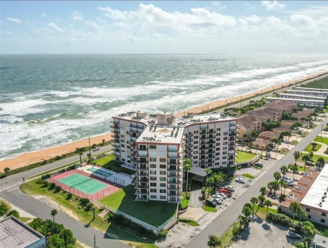 birds eye view of property with a beach view and a water view