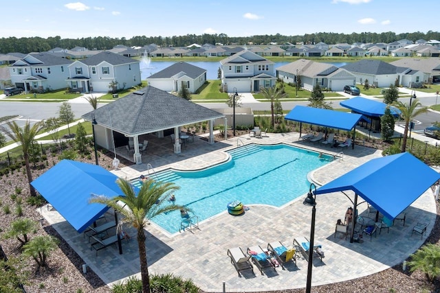 pool featuring a residential view, fence, and a patio area