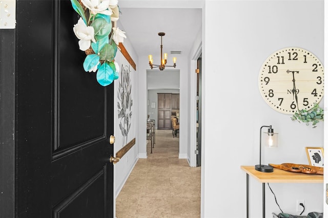 562 Kendall Crossing Dr, Saint Johns, FL 32259 - hallway with light tile patterned floors, baseboards, and a notable chandelier