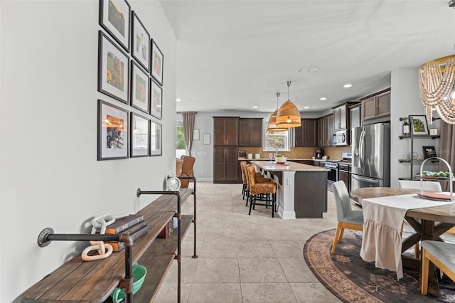 562 Kendall Crossing Dr, Saint Johns, FL 32259 - dining room featuring recessed lighting, plenty of natural light, light tile patterned floors, and a notable chandelier