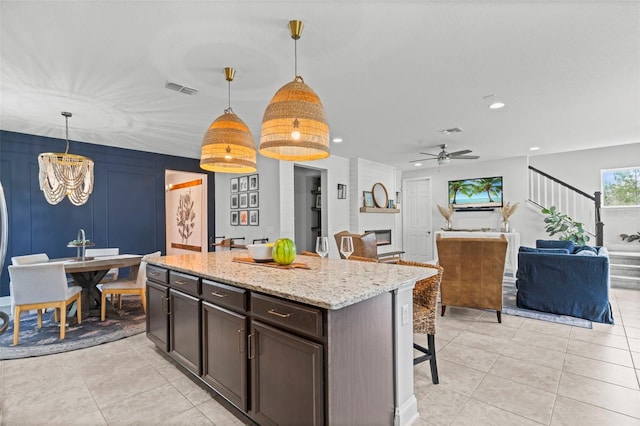 562 Kendall Crossing Dr, Saint Johns, FL 32259 - kitchen with visible vents, a breakfast bar, decorative light fixtures, and light tile patterned floors