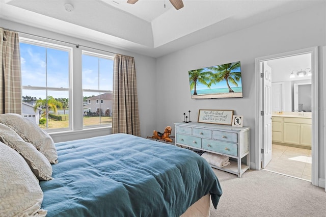 562 Kendall Crossing Dr, Saint Johns, FL 32259 - carpeted bedroom with ensuite bath, multiple windows, a ceiling fan, and a raised ceiling