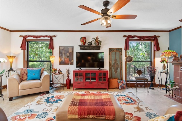 tiled living area featuring ceiling fan and ornamental molding