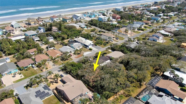 birds eye view of property featuring a view of the beach, a residential view, and a water view