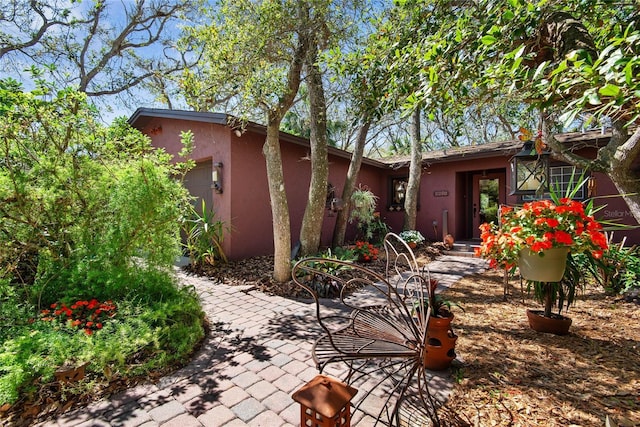 exterior space with stucco siding and an attached garage