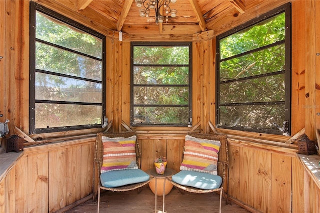 unfurnished sunroom featuring plenty of natural light and lofted ceiling