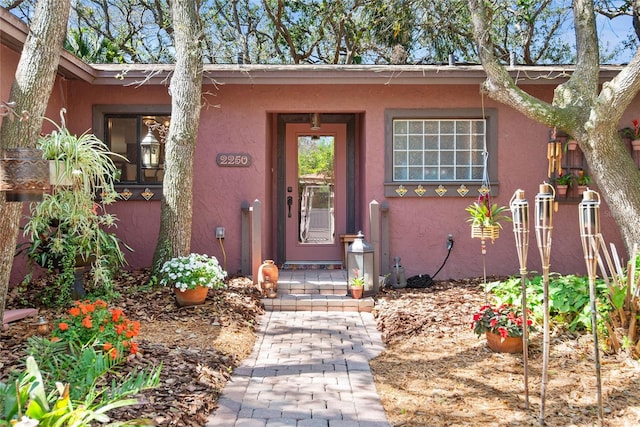 property entrance with stucco siding