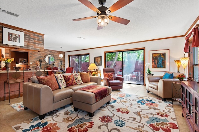 living area with light tile patterned floors, visible vents, ceiling fan, a textured ceiling, and crown molding
