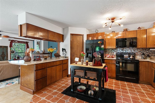 kitchen with backsplash, brown cabinets, black appliances, and light countertops