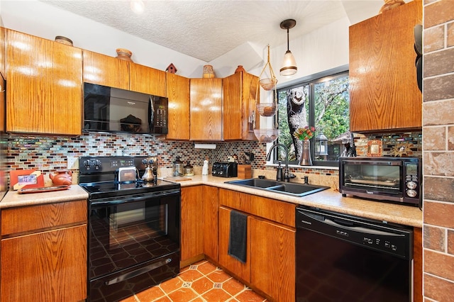 kitchen with black appliances, a sink, backsplash, brown cabinetry, and light countertops