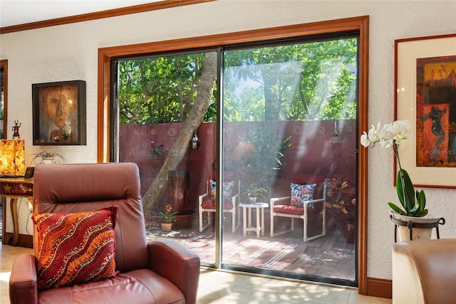 doorway to outside featuring ornamental molding and a textured wall