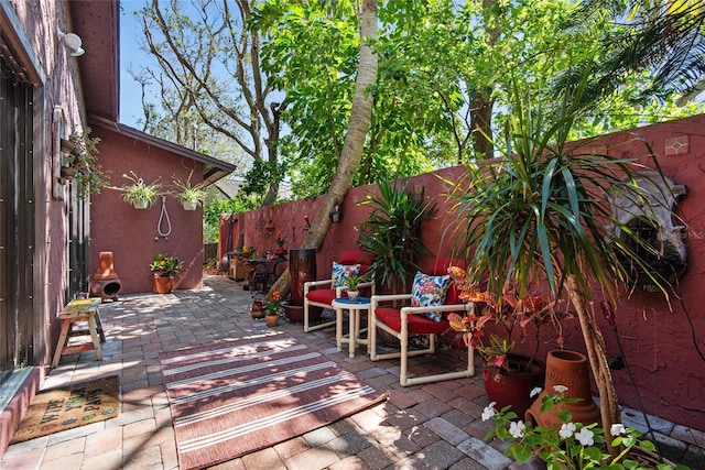 wooden deck with a fenced backyard and a patio