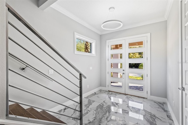 entrance foyer featuring marble finish floor, crown molding, stairway, and baseboards