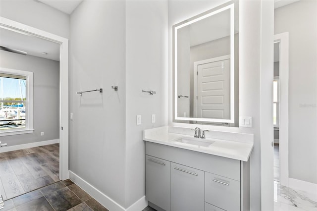 bathroom with vanity and baseboards