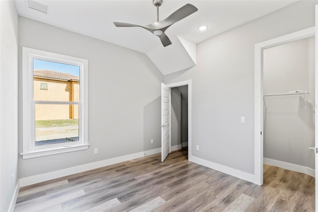 unfurnished bedroom featuring baseboards, a closet, visible vents, and wood finished floors