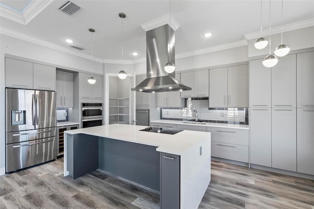 kitchen with stainless steel appliances, a sink, visible vents, modern cabinets, and island exhaust hood