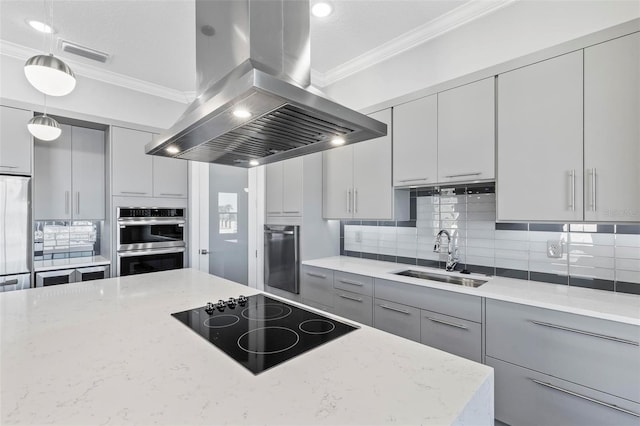 kitchen with gray cabinetry, double oven, a sink, island range hood, and black electric cooktop