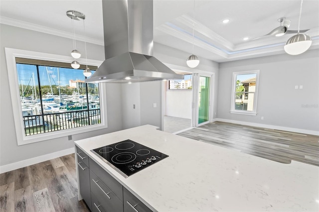 kitchen with black electric stovetop, dark wood-style flooring, baseboards, island exhaust hood, and crown molding