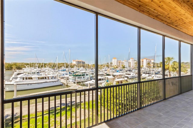 sunroom / solarium featuring a water view and a view of city