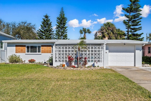 view of front facade with a garage, driveway, and a front lawn