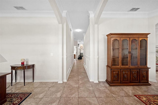 hallway featuring visible vents and ornamental molding