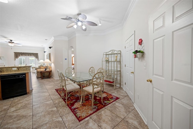 dining area with arched walkways, ceiling fan, light tile patterned flooring, baseboards, and crown molding