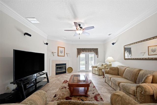 tiled living room featuring ornamental molding, ceiling fan, french doors, and visible vents