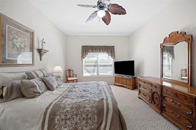 bedroom with light carpet and ceiling fan