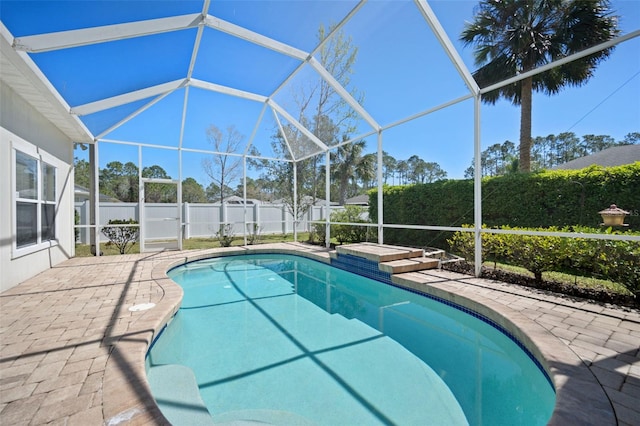 view of pool with a patio area, a fenced backyard, and a lanai