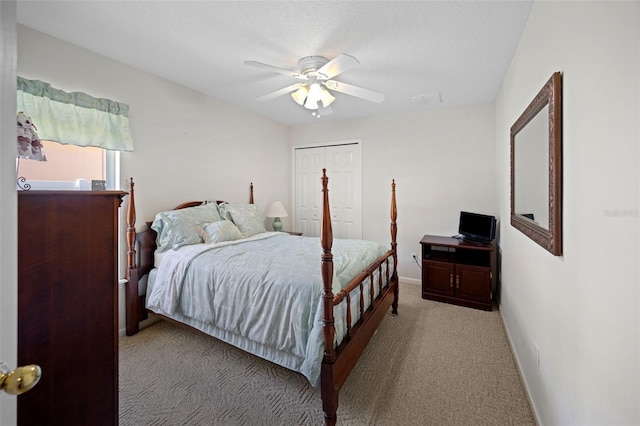 bedroom featuring ceiling fan, visible vents, baseboards, a closet, and carpet