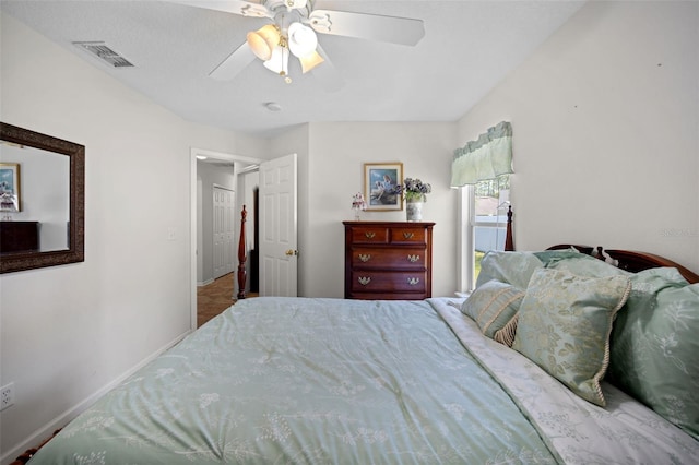 bedroom featuring a ceiling fan, visible vents, and baseboards