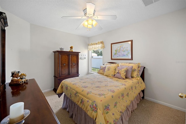 bedroom with light carpet, ceiling fan, visible vents, and baseboards