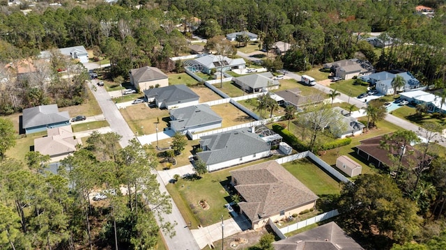 birds eye view of property with a residential view and a view of trees