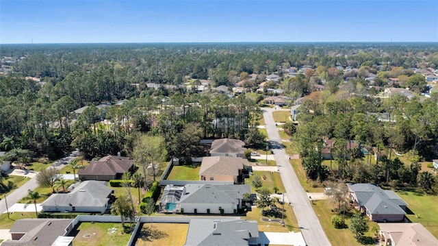 birds eye view of property featuring a forest view and a residential view